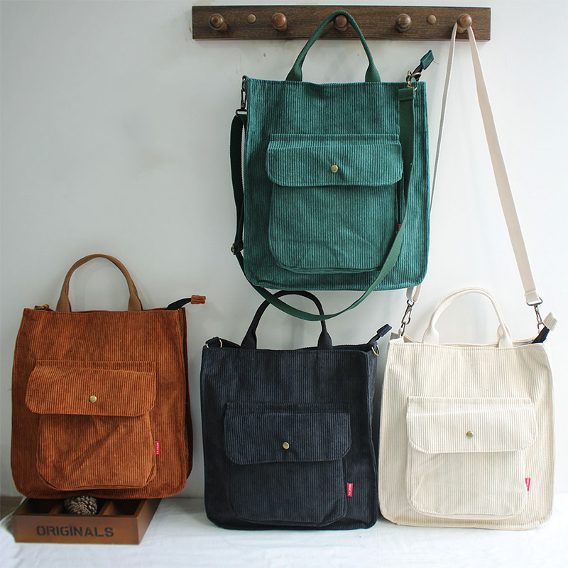 Fashion ladies corduroy handbags in three colors, stylish and casual tote bags hanging on a wall.