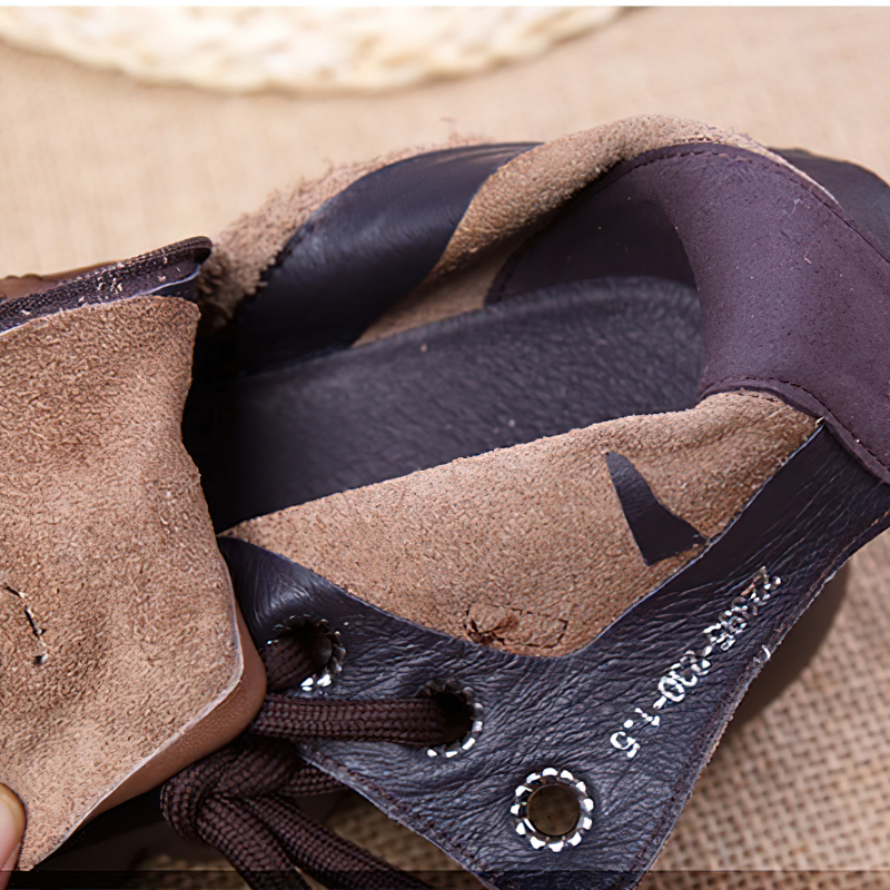 Close-up of the interior texture of brown genuine leather ankle boots for women, showcasing casual fashion style.