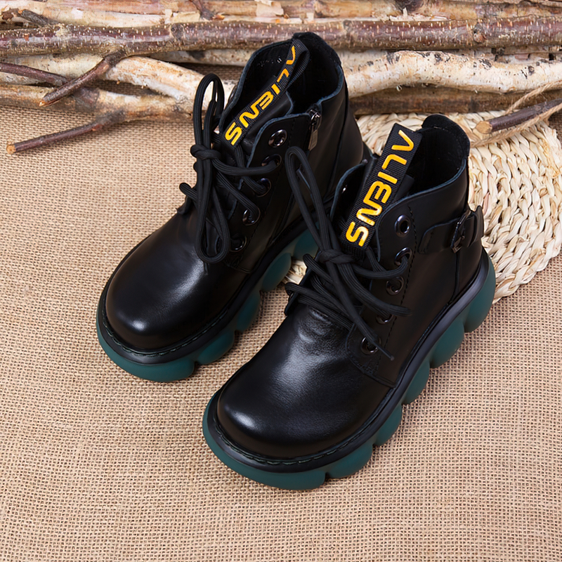 Fashion ladies black leather ankle boots with thick green platforms and yellow laces, perfect for casual outfits.