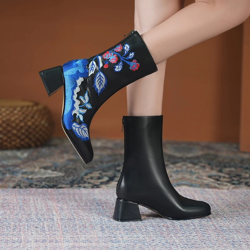 Elegant black leather ankle boots with ethnic embroidery and comfortable square heels, perfect for stylish casual wear.