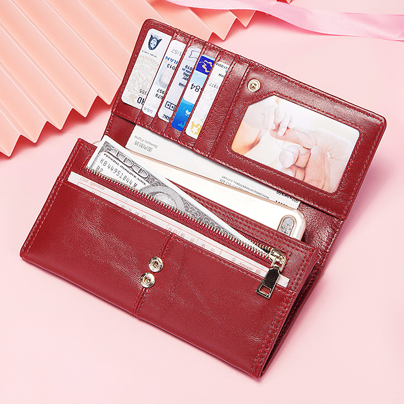 Stylish red genuine leather wallet open, showcasing card slots, ID window, and zippered pocket for cash and small essentials.