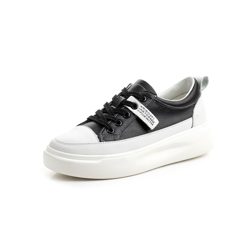 Stylish ladies lace-up genuine leather sneakers in black and white with platform sole and casual appeal.