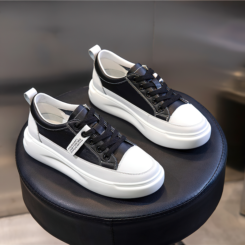 Fashion ladies' lace-up genuine leather sneakers on a black stool. Comfortable casual footwear for stylish outfits.