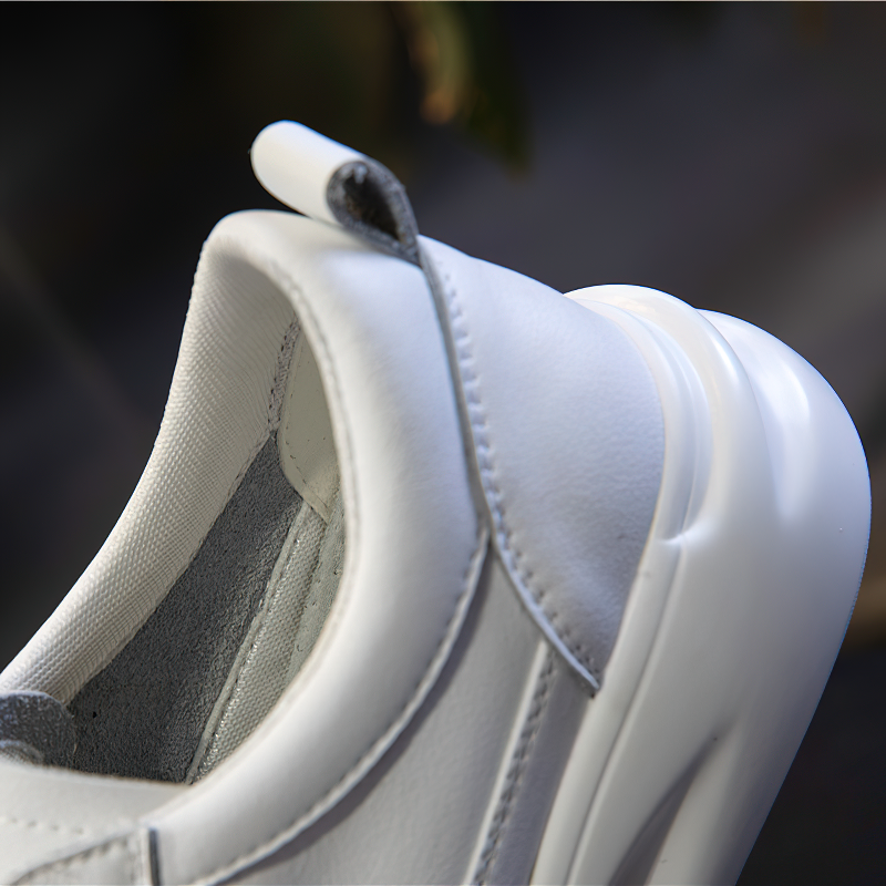 Close-up of stylish white lace-up genuine leather sneakers with a sleek design and comfy platform.