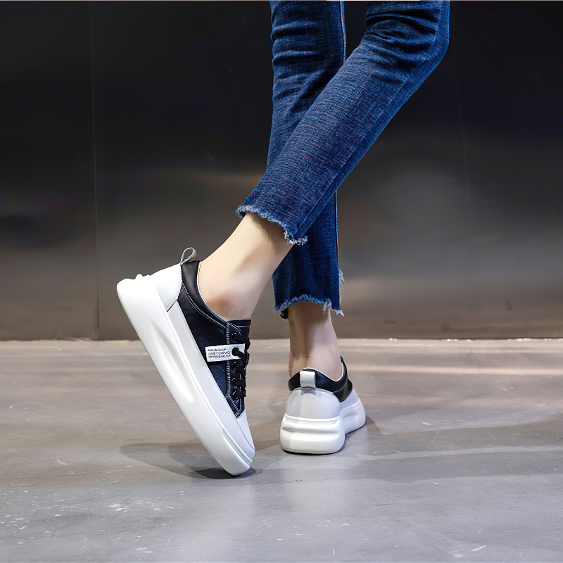 Fashion ladies lace-up genuine leather sneakers showcased with casual denim jeans, perfect for stylish comfort.