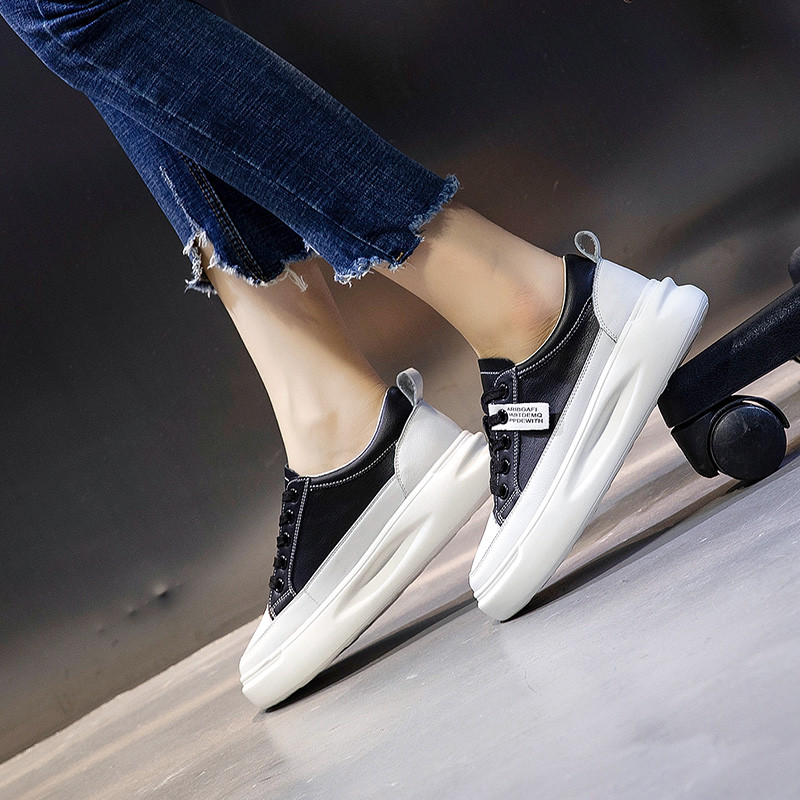 Fashion ladies lace-up genuine leather sneakers in black and white, perfect for casual and stylish outfits.