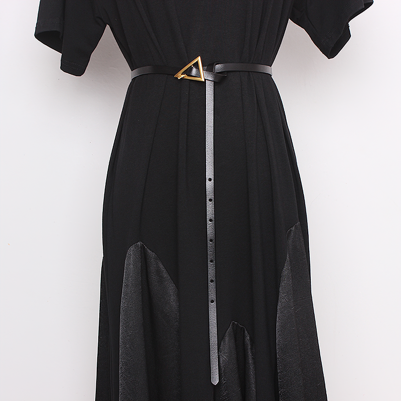 Elegant ladies PU leather belt with metal triangle buckle styled on a black dress for a trendy look.