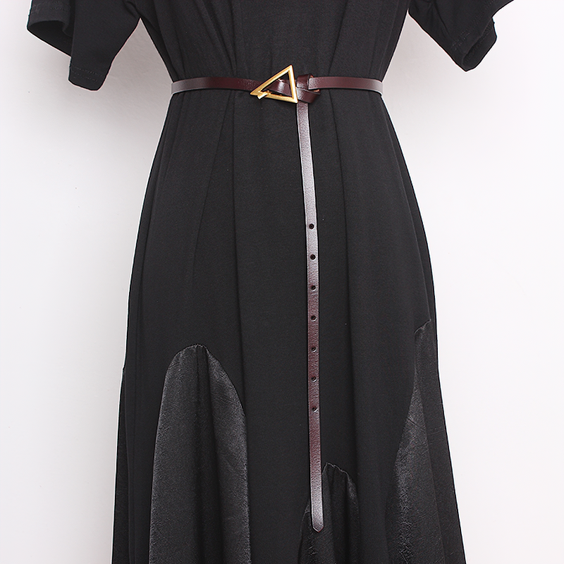 Fashion ladies PU leather belt with an elegant metal triangle buckle styled on a black dress.