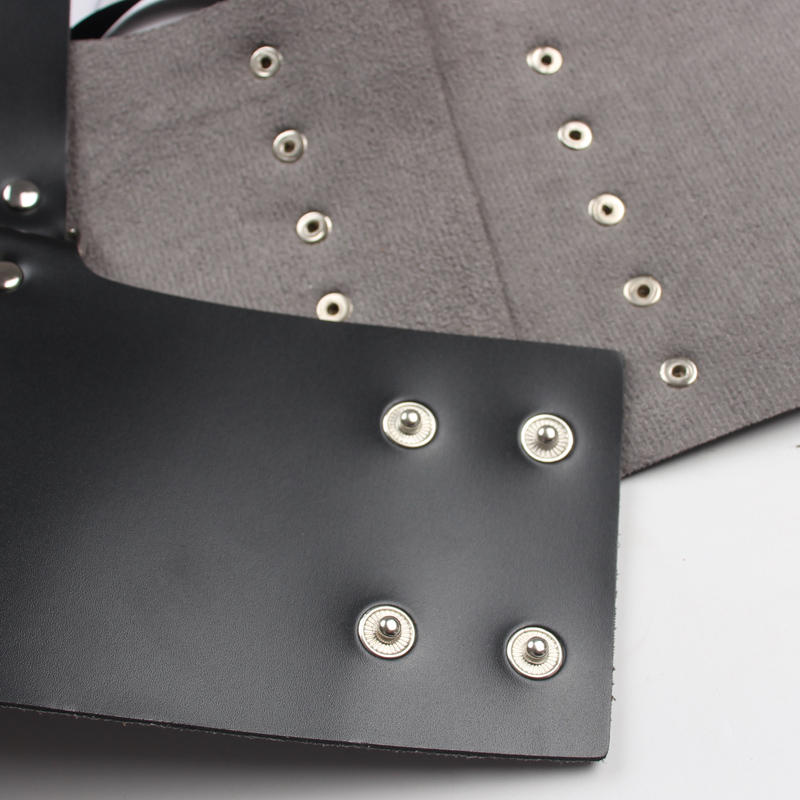 Close-up of adjustable PU leather corset body belt with silver eyelets and buttons, perfect for trendy outfits.