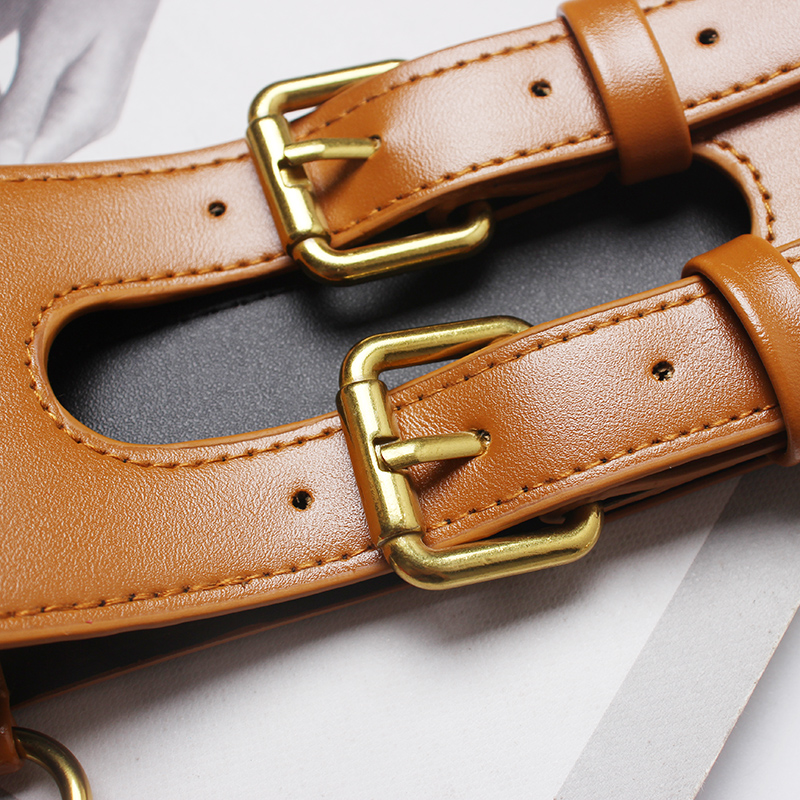 Close-up of fashionable tan PU leather corset belt showcasing sturdy metal buckles and double-breasted design.