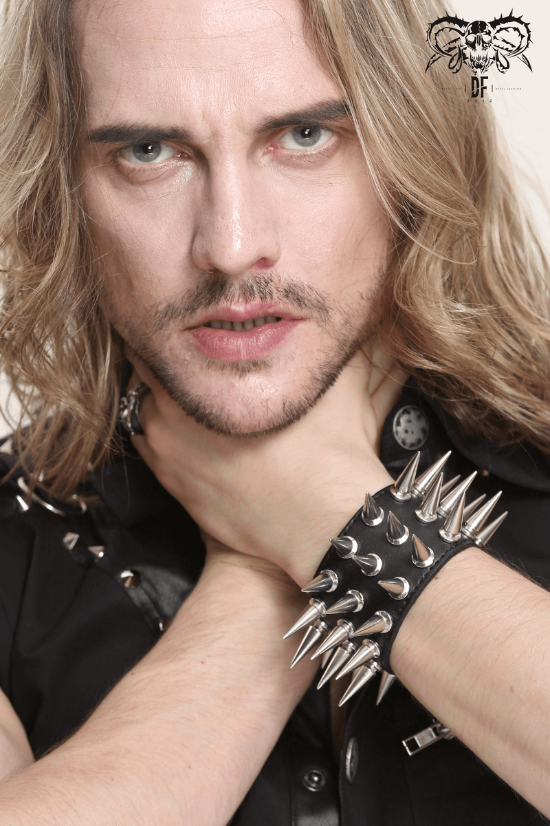 Stylish man showcasing a punk unisex leather bracelet with silver spikes, adding edgy flair to his look.