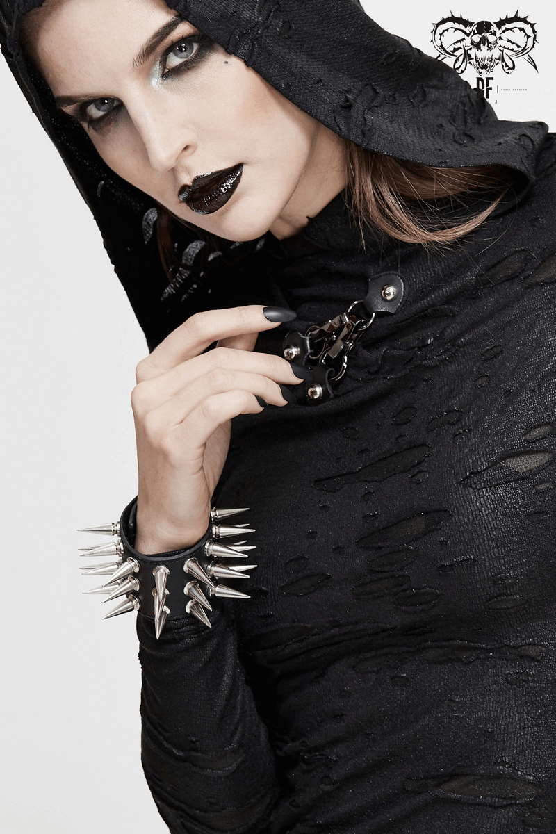 Fashion model showcasing a stylish black punk hoodie and a spiked leather bracelet as a dramatic hand accessory.