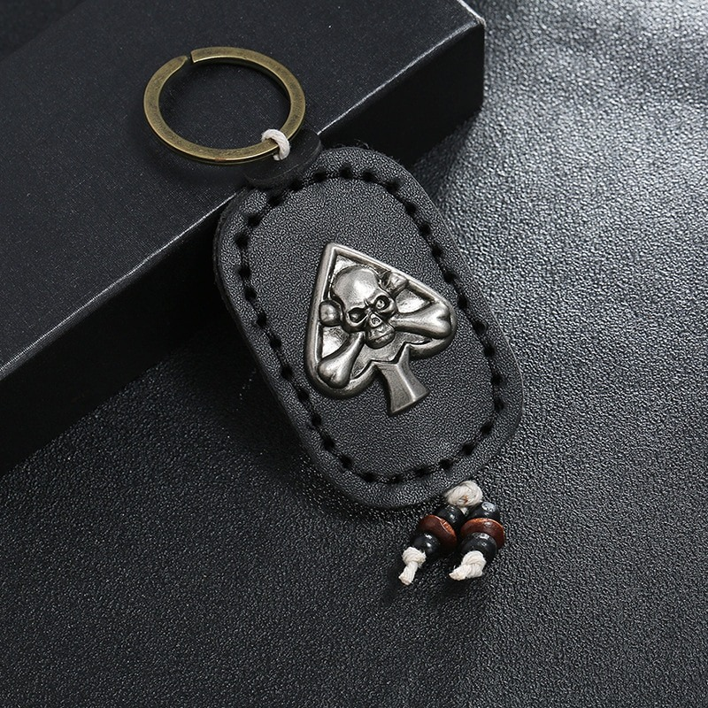 Gothic leather skull keychain with silver pendant, stylish accessory for bags or car keys.