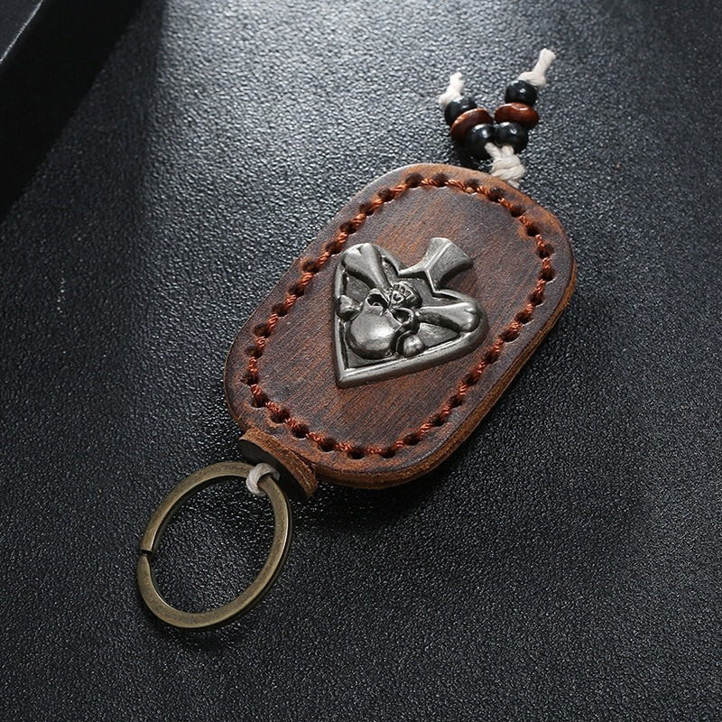 Gothic leather keychain with skull pendant, unisex accessory for bags or car keys.