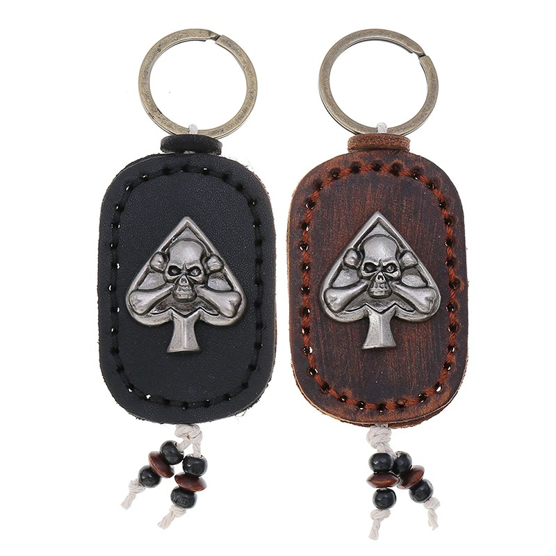 Gothic leather skull keychain set with spade design in black and brown colors, perfect for bags and car keys.