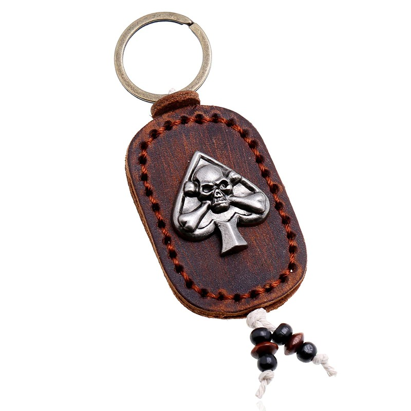 Fashion leather skull keychain with spade design, perfect gothic accessory for bags and car keys.