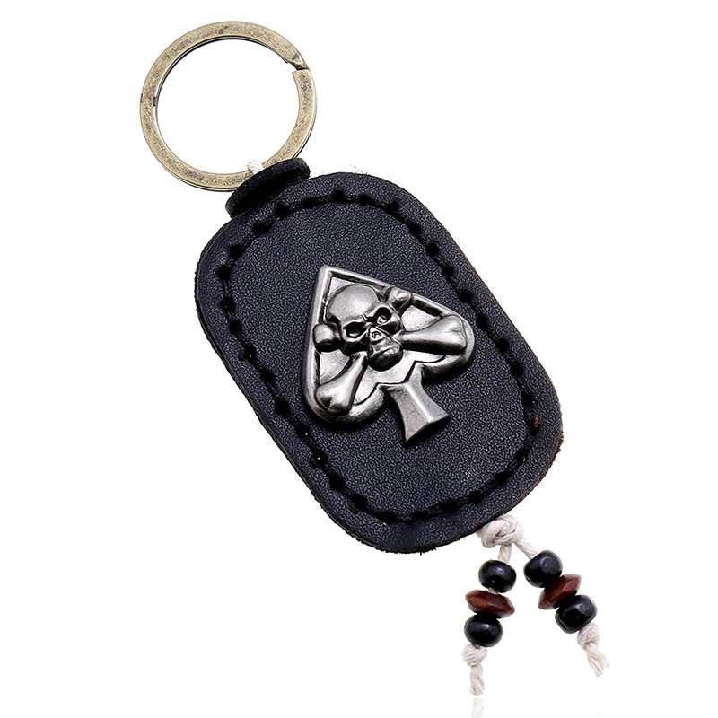 Gothic leather skull keychain with silver spade pendant, perfect accessory for bags or car keys.