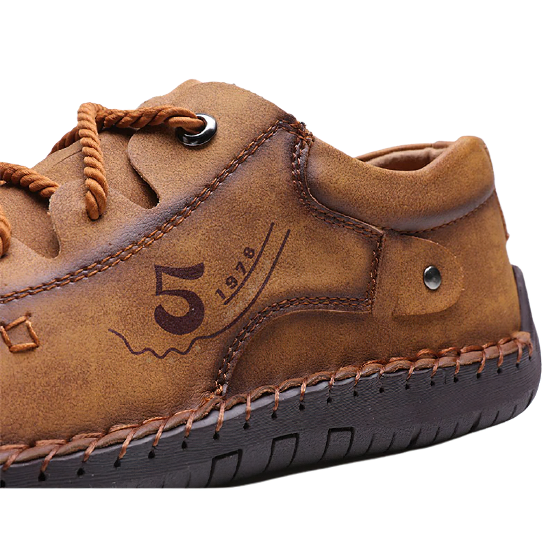 Close-up of brown men's casual loafers featuring leather and decorative stitching, ideal for casual wear.
