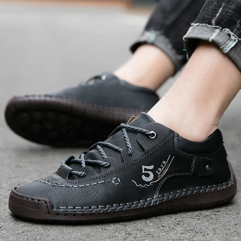 Men's black casual loafers made from genuine leather, perfect for everyday wear and stylish comfort.