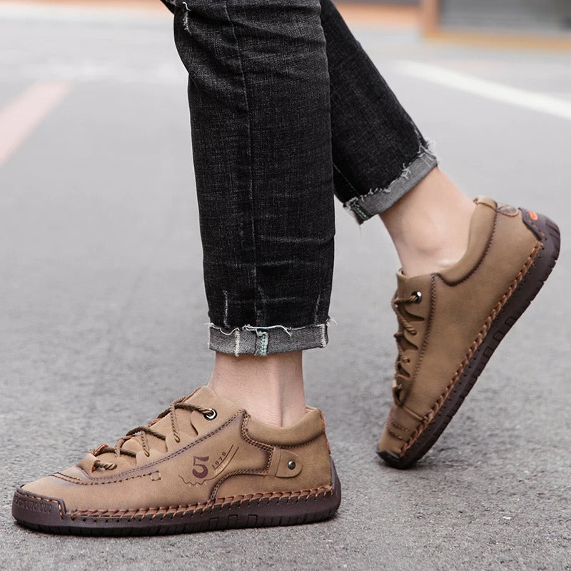 Men's casual loafers in brown leather, perfect for spring and summer outings, styled with jeans.