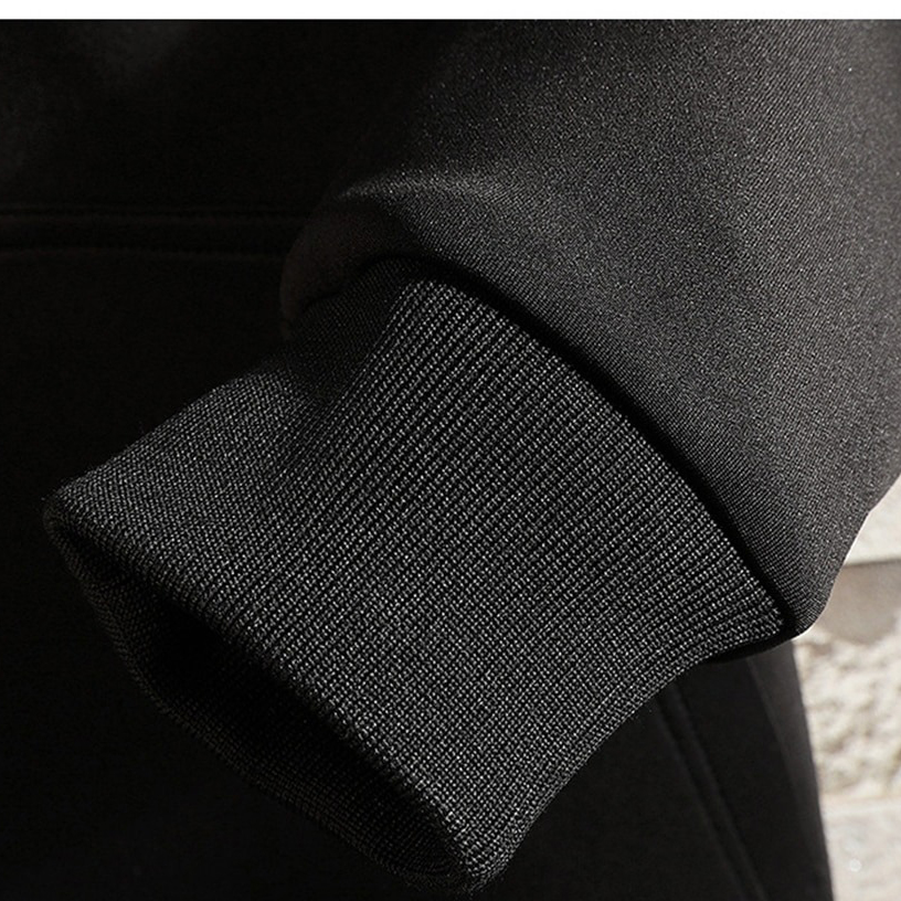 Close-up of the cuff on a black fashionable men's coat, showcasing the stylish knit design and comfortable fit.