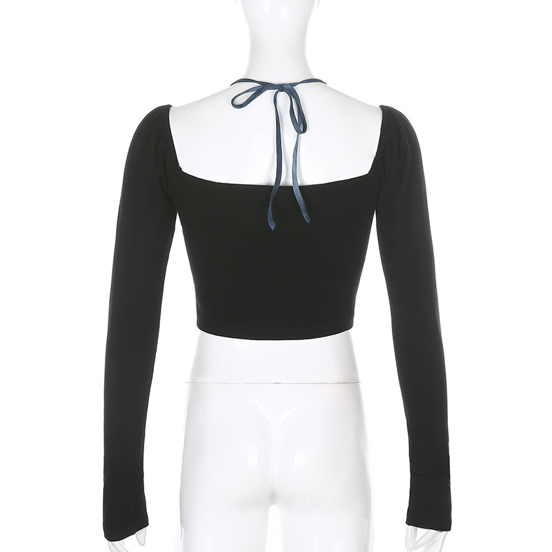 Back view of women's black gothic crop top with long sleeves and ribbon tie.