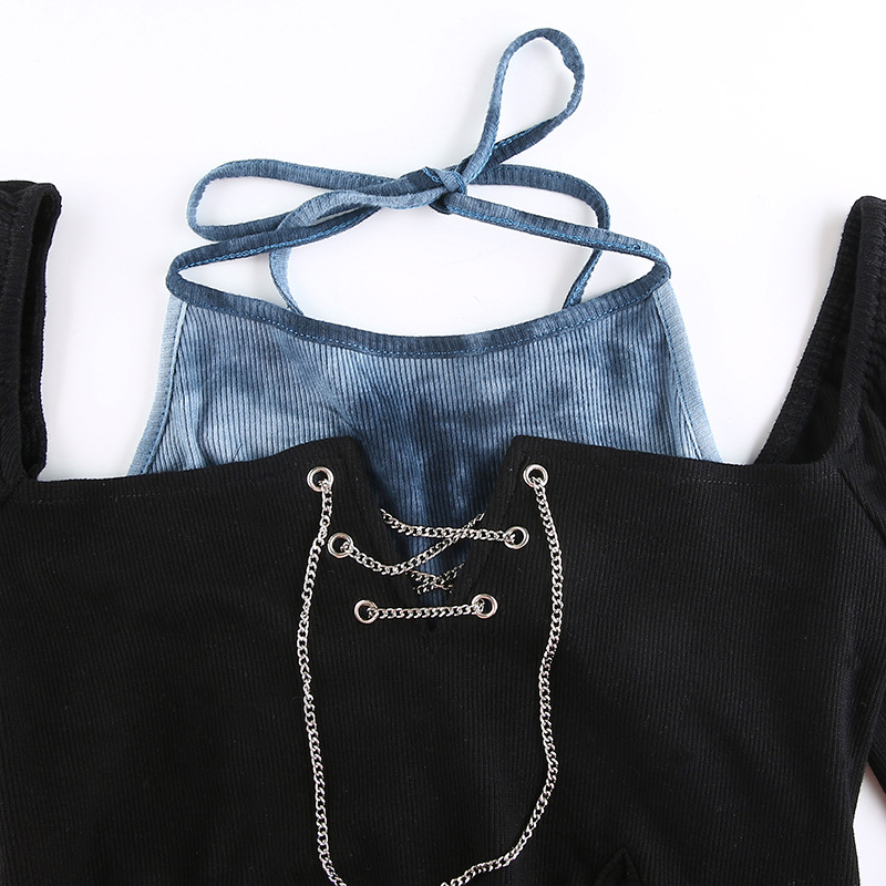 Black and blue patchwork crop top with silver chain detail, showcasing a gothic style perfect for edgy fashion.