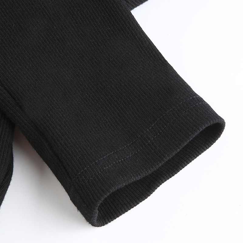 Close-up view of the sleeve detail on a women's black gothic crop top with ribbed texture.