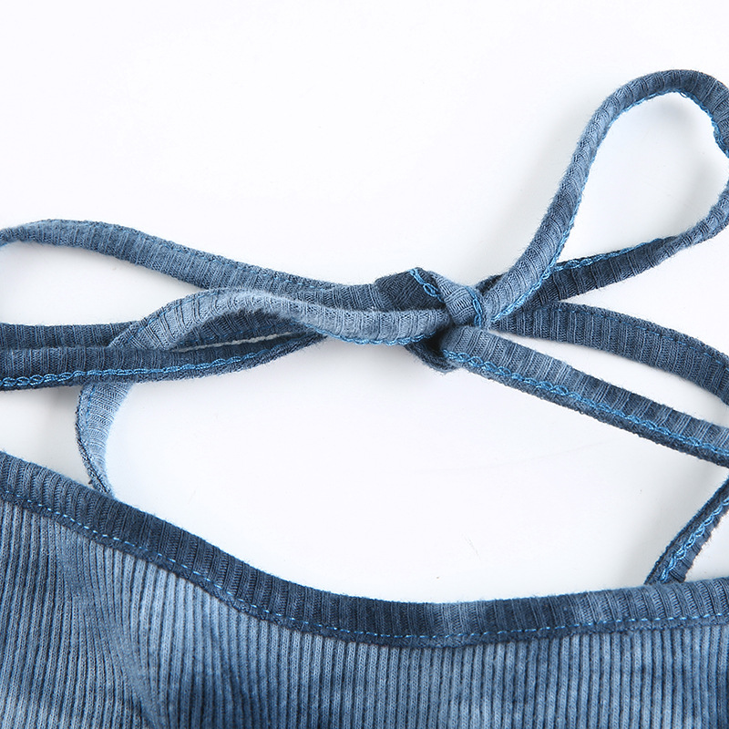 Close-up of a blue crop top's stylish tied straps, showcasing soft corduroy texture and intricate design.