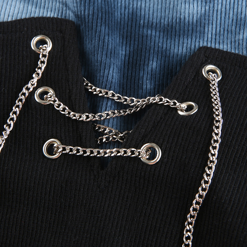 Close-up of women’s gothic black crop top featuring silver chain lacing detail, stylish and trendy design.