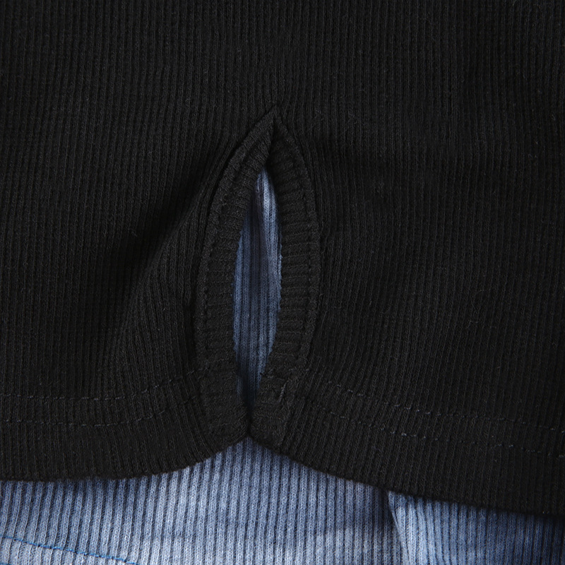 Close-up of a stylish black crop top showcasing a unique cutout detail for women's gothic fashion.