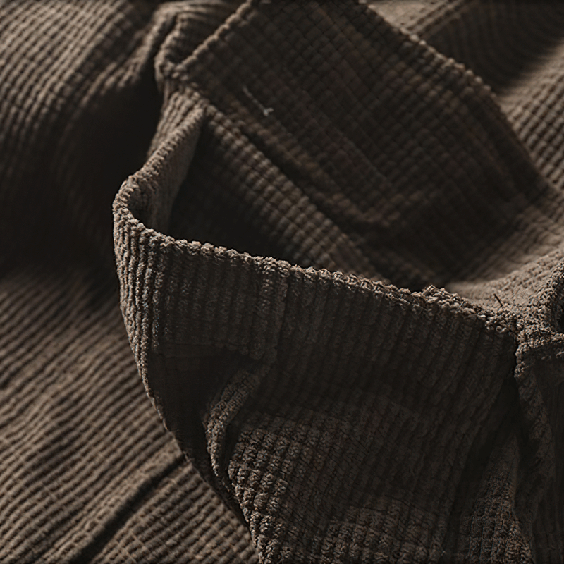 Close-up of a soft brown textured fabric of an oversized men's shirt with a relaxed style.