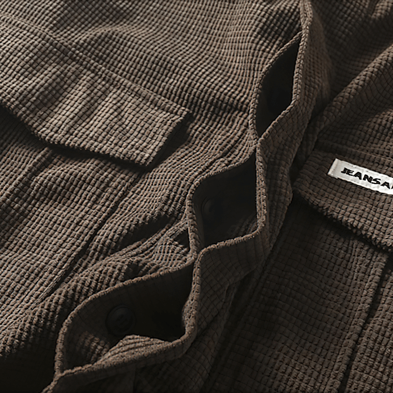 Fashionable men's oversized shirt featuring two big pockets in a textured brown fabric.