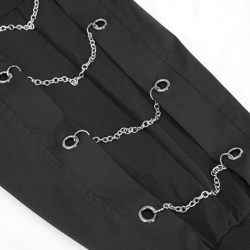 Close-up of stylish black cargo pants featuring silver chain eyelets for a punk look.