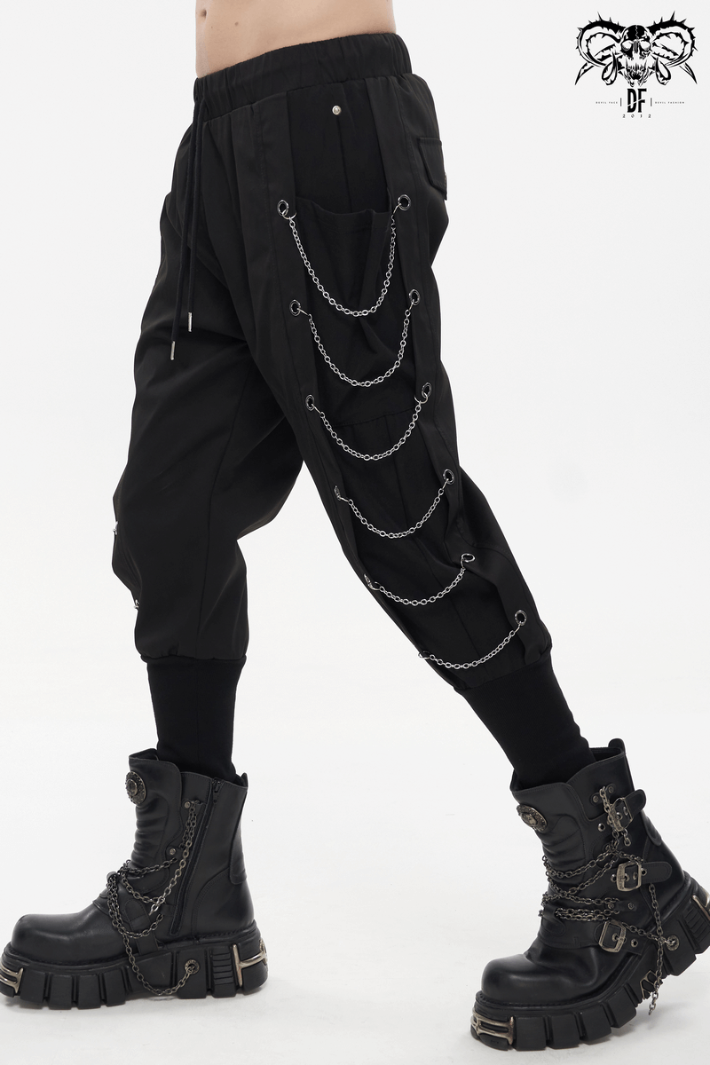 Men's loose cargo pants with chain eyelets, stylishly paired with rugged black boots, in a punk fashion look.