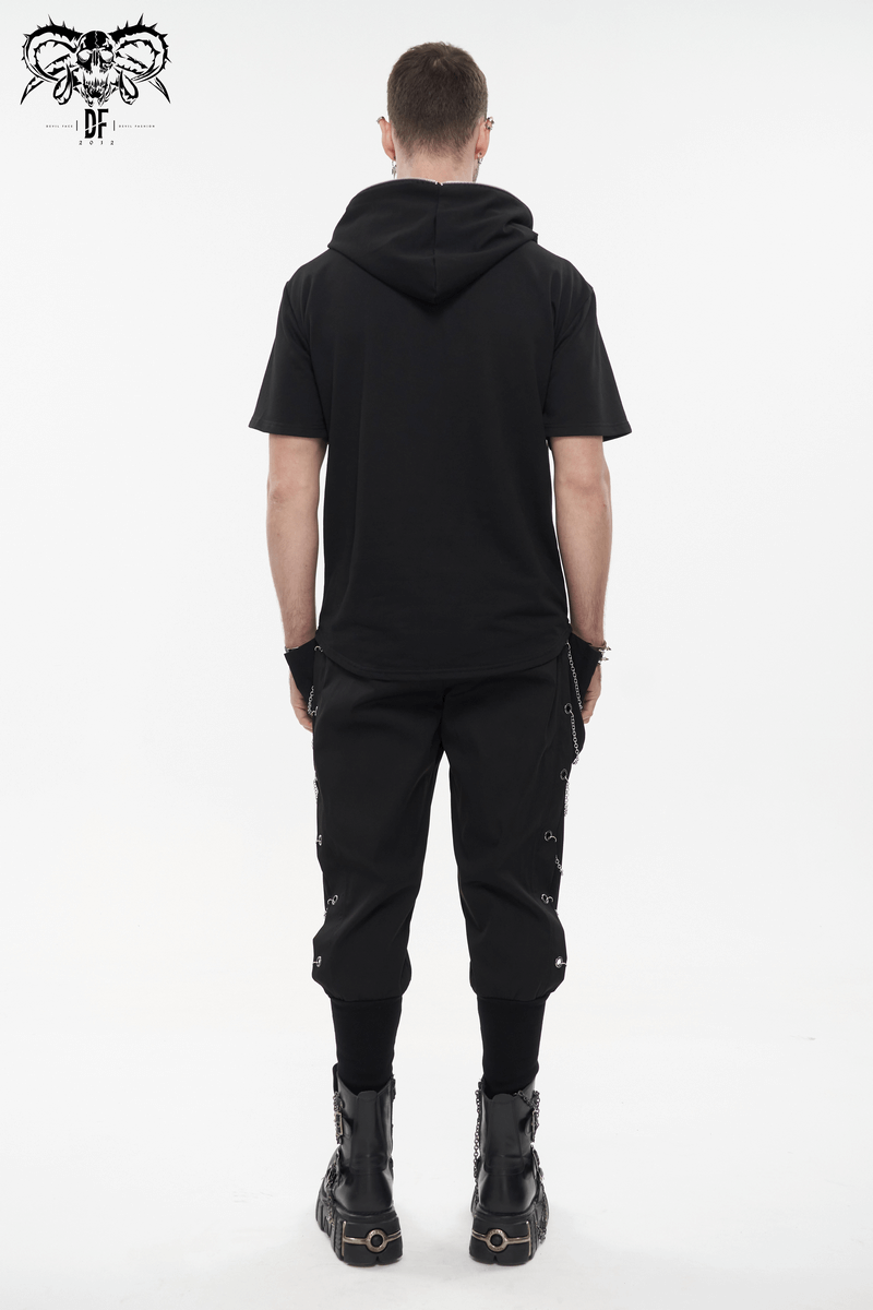 Men's black outfit featuring loose cargo pants with chain eyelets and a short-sleeve hoodie, showcasing a punk style.