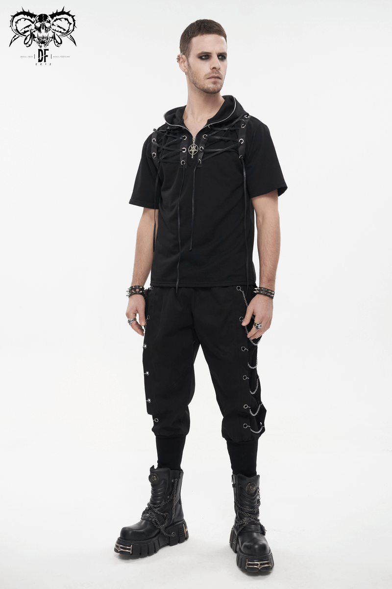 Model showcasing loose cargo pants with chain eyelets and a hooded top, perfect for a gothic punk style.
