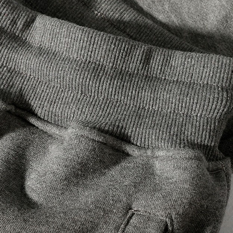 Close-up of the elastic waistband of grey casual loose pants for men, showcasing comfort and style.