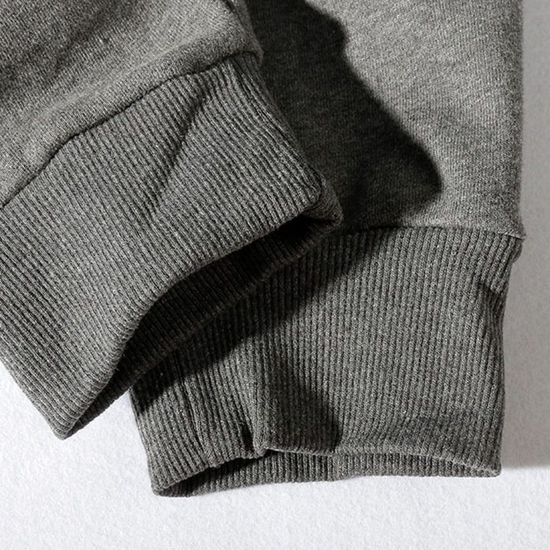 Close-up of the elastic cuffs of gray men's casual drawstring pants, showcasing soft fabric and comfortable fit.