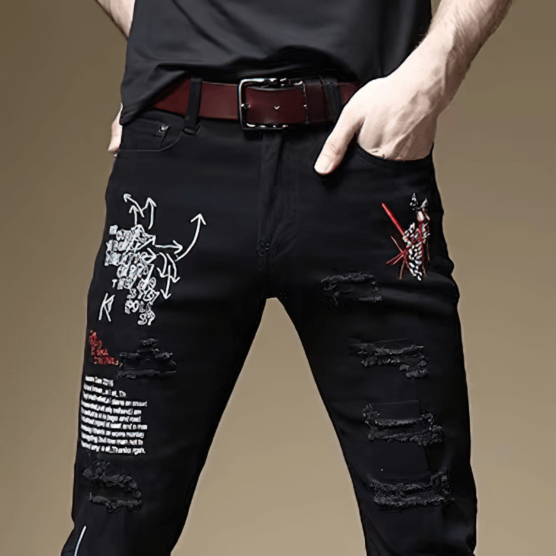 Stylish men's slim jeans with artistic prints and distressed details, perfect for a casual look.