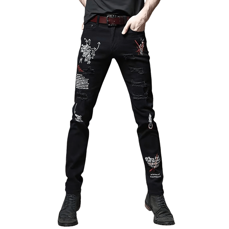 Stylish male model showcasing black slim jeans with trendy printed designs and ripped details, perfect for casual wear.
