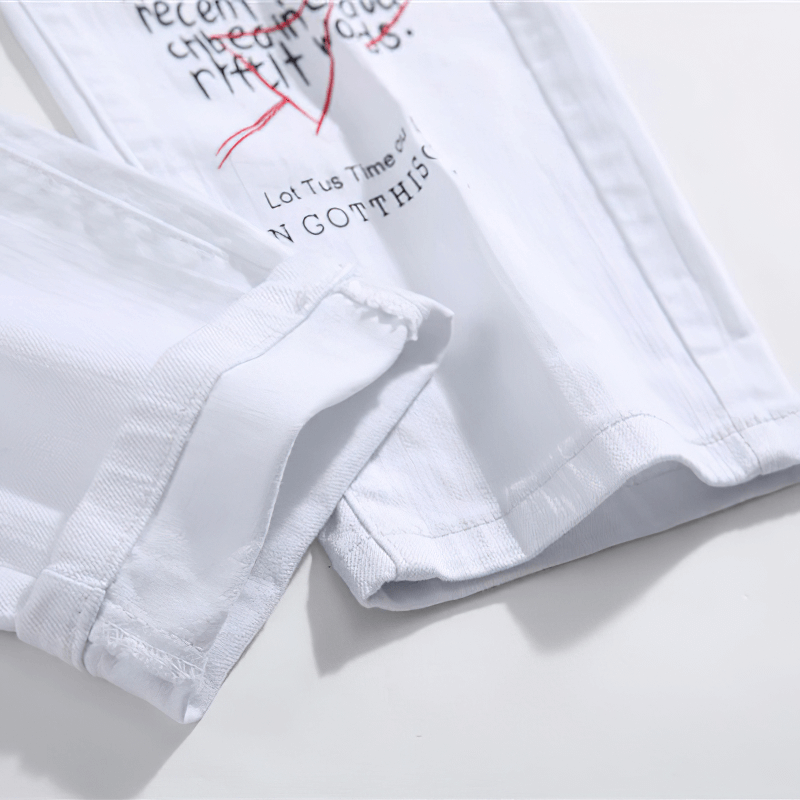 Close-up of men's slim jeans with stylish letter print detailing and hem design, perfect for casual outfits.