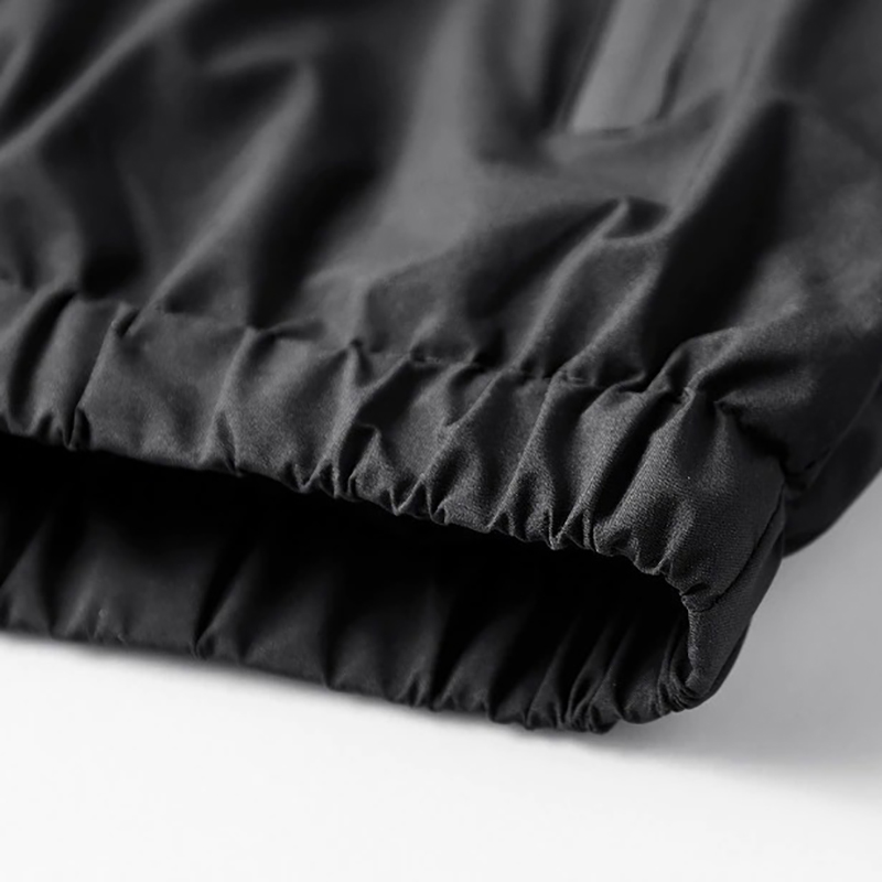 Close-up of the cuff of a black male zip-up jacket with smooth fabric, showcasing stylish and comfortable design.