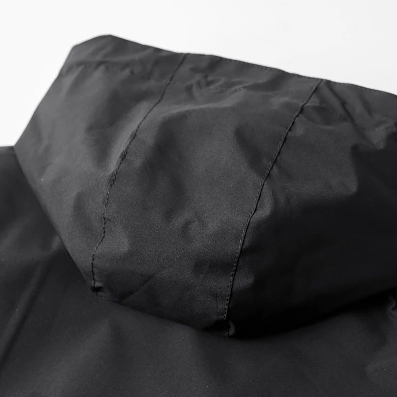 Close-up of the hood on a stylish black zip-up men's jacket, perfect for casual wear in cold weather.
