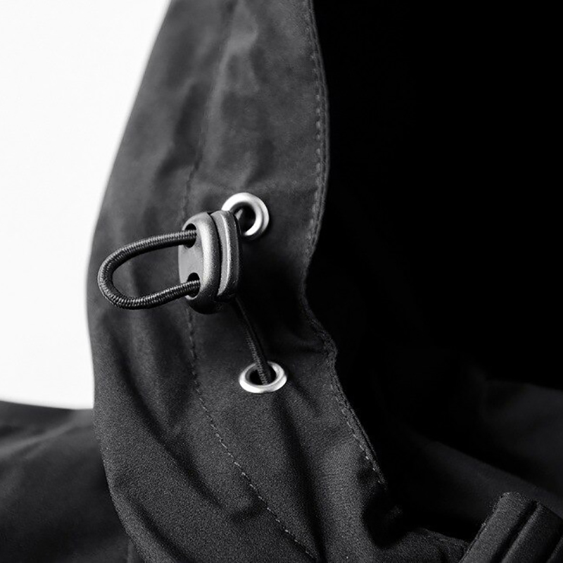 Close-up of the hood and drawstring detail on a stylish black zip-up jacket for men, showcasing casual fashion.