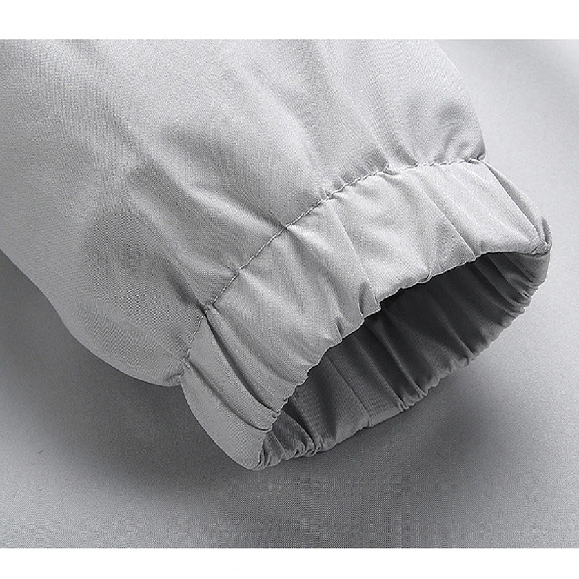 Close-up of the cuff of a grey male zip-up jacket showcasing stylish elastic hem for a comfortable fit.