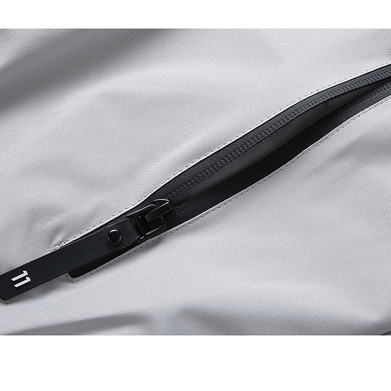 Close-up of a stylish zippered pocket on a men's long sleeve zip-up jacket, showcasing its sleek design and functionality.