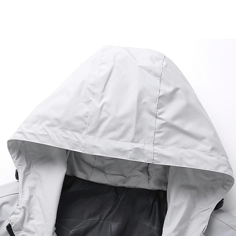 Close-up of a cozy gray hoodie on a men's zip-up jacket, showcasing stylish design and warm lining for cold weather.