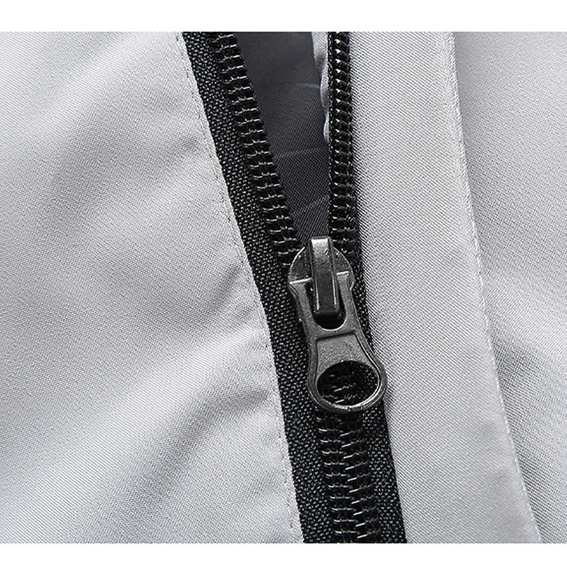Close-up of a sleek zipper on a men's long sleeve zip-up jacket with a stylish hood.