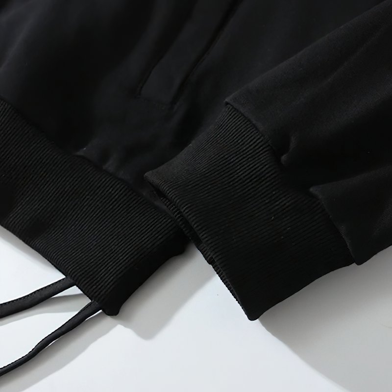 Close-up of black oversized men's zipper hoodie cuffs and drawstrings for a casual punk style.